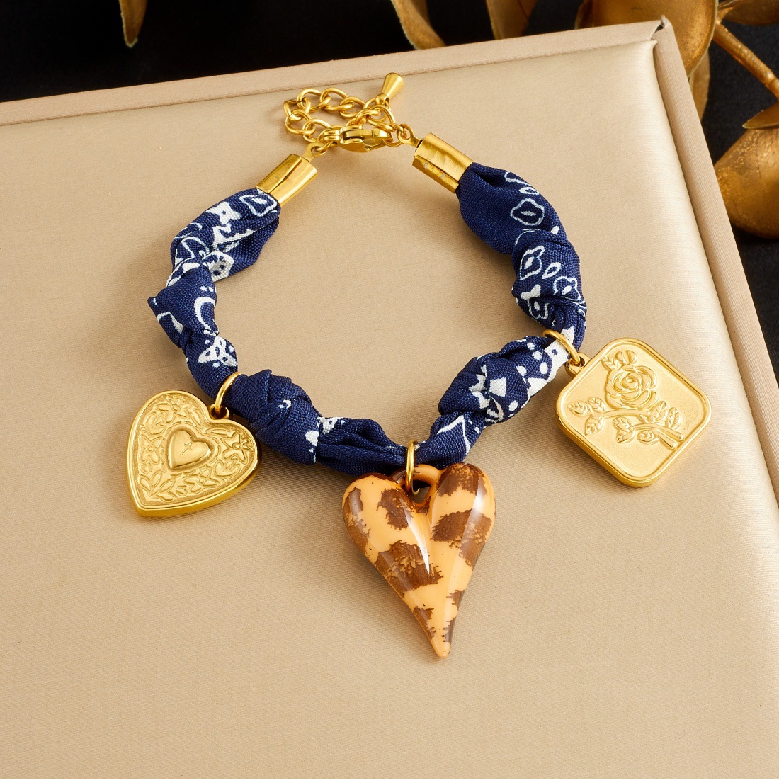 Gold-Tone Bracelet with Blue Printed Fabric and Mixed Charms